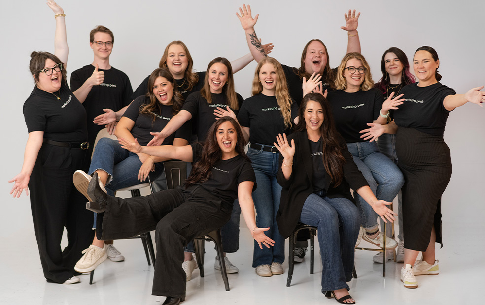 rock-city-digital-group-happy A joyful assembly of Rock City Digital coworkers in black shirts gather for a photo, reflecting their camaraderie and unity.