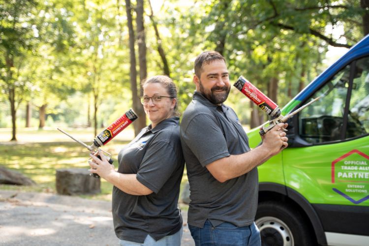 Two people making a heart & smiling