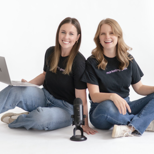 Adrienne, senior web designer, and Hannah, junior web designer, share a fist bump, smiling brightly, illustrating a bond of friendship.
