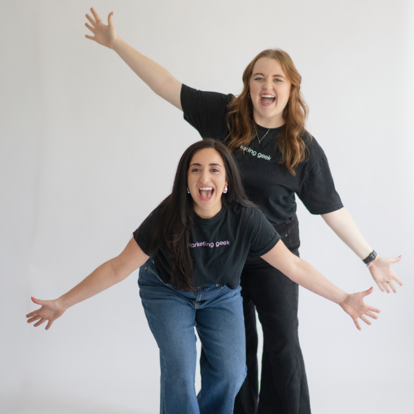 Montie, production geek and photographer stands with her hands on her hips smiling confidently, showcasing her joyful attitude.